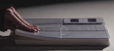 A video showcasing the Cloth & Paper collection — hands gliding through planners, journaling, and stamping pages with intention.