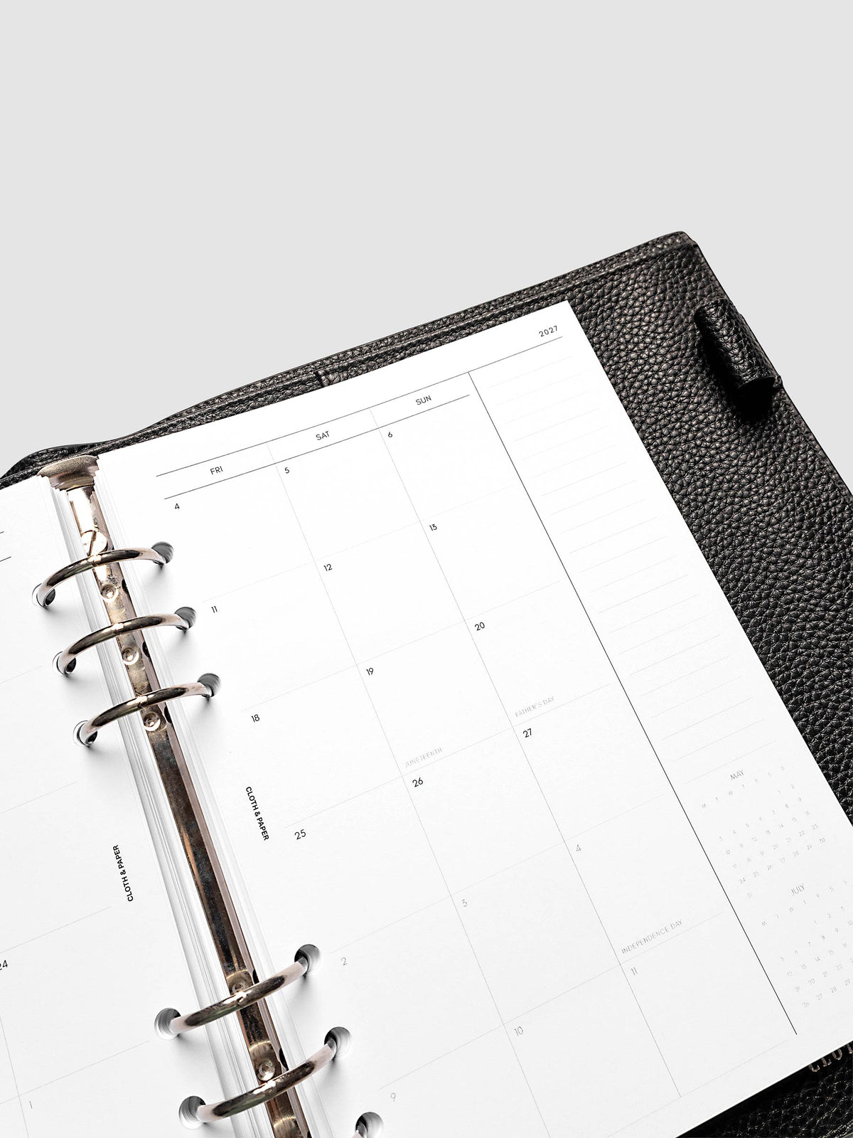 2027 Dated Monthly Planner Inserts, Monday Start, A5 6-Ring Punch, close-up detail of right page monthly calendar with notes column along the far right shown inside a planner