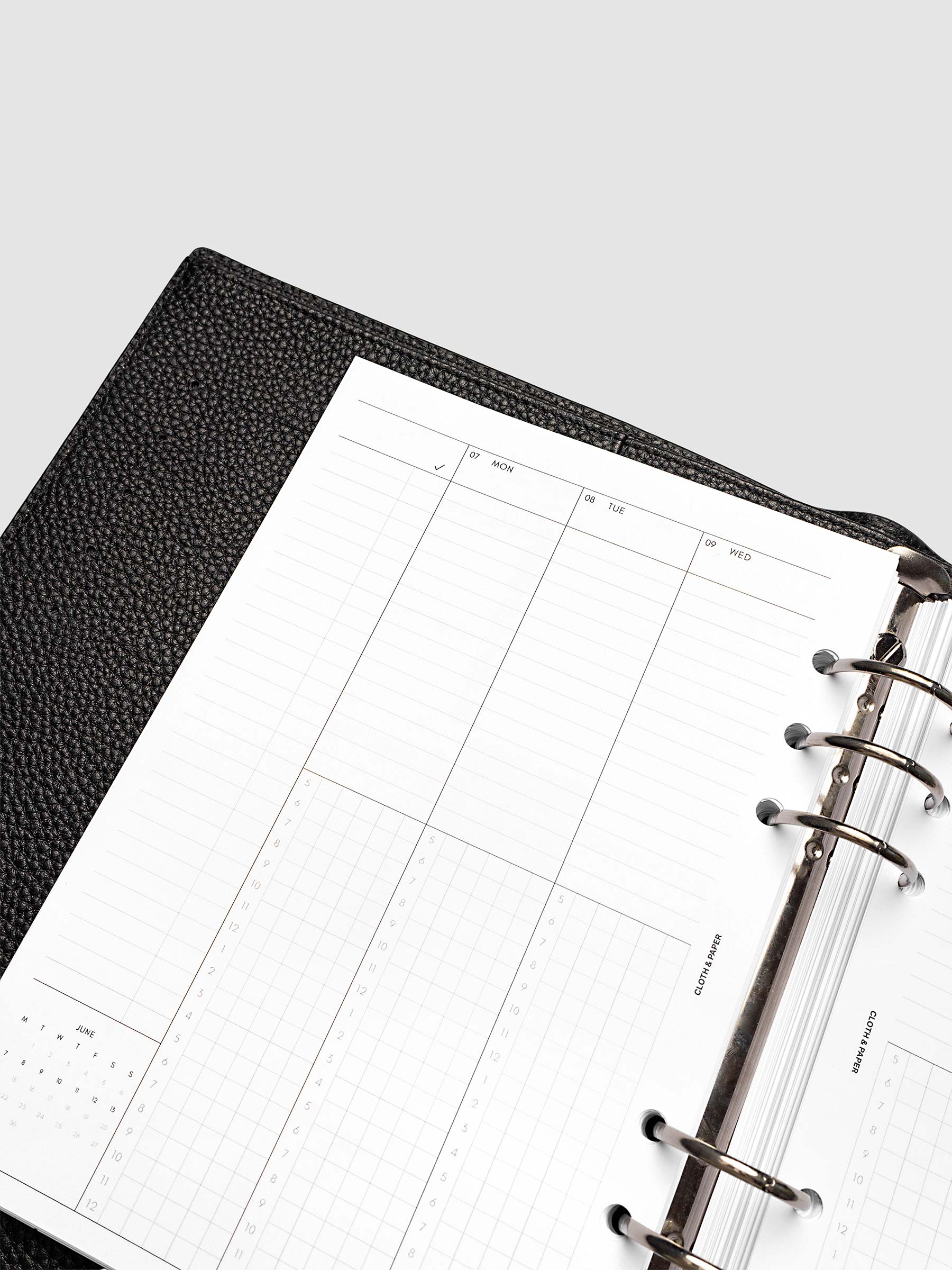 Punch left page detail showing task column, mini monthly calendar, and lined section in a planner