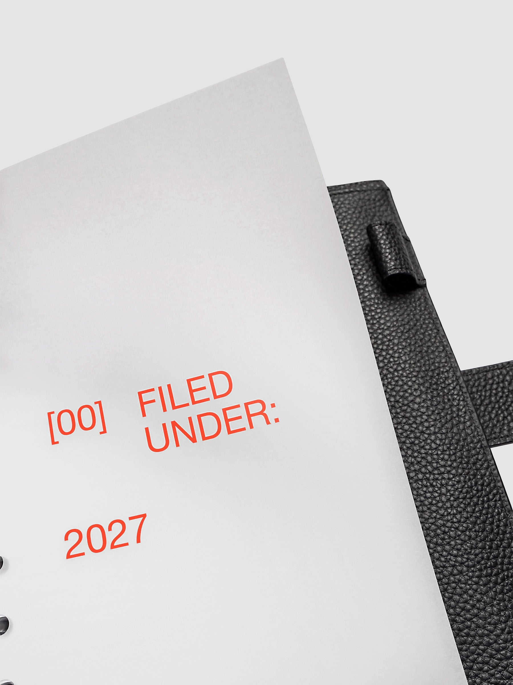2027 Front + Monthly Dashboard Overlays, Saffron, A5 6-Ring Punch, close-up of a vellum dashboard overlay lifted to show the translucent layering effect inside a planner
