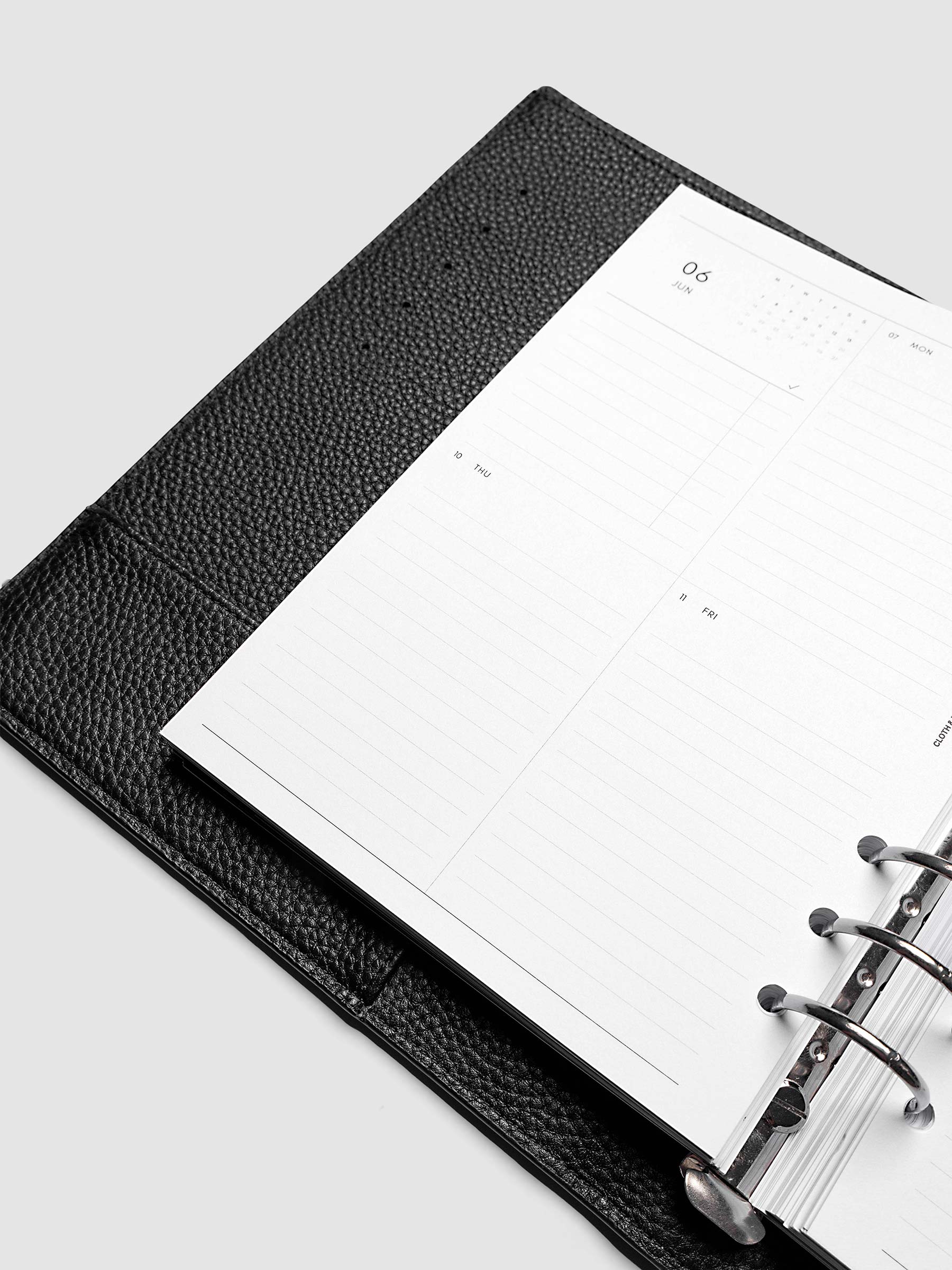 2027 Dated Weekly Vertical Planner Inserts, Monday Start, A5 6-Ring Punch, close-up of the bottom of the left page showing the lower daily grid sections with lined areas for notes and appointments